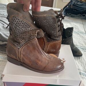 Brown ankle boots with lace-up front and intricate perforated design